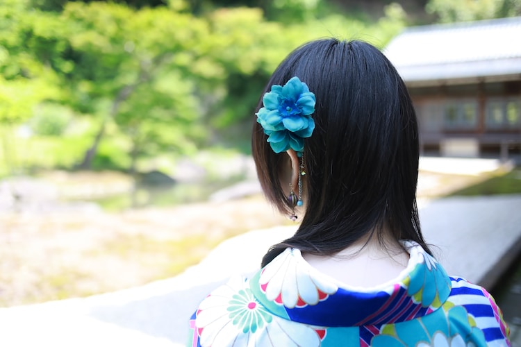 selective focus photography of woman wearing blue and white traditional dress